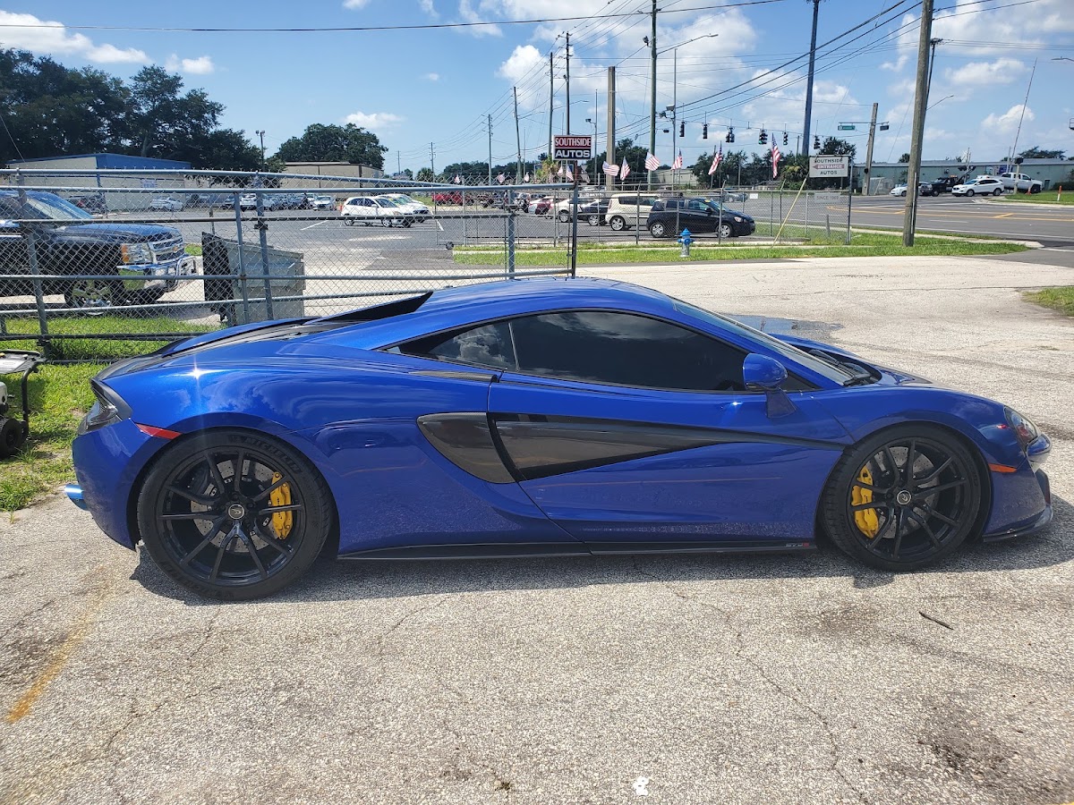 GSA Auto Detailing shop on S Orange Blossom Trl in Orlando, with a detailed blue McLaren
